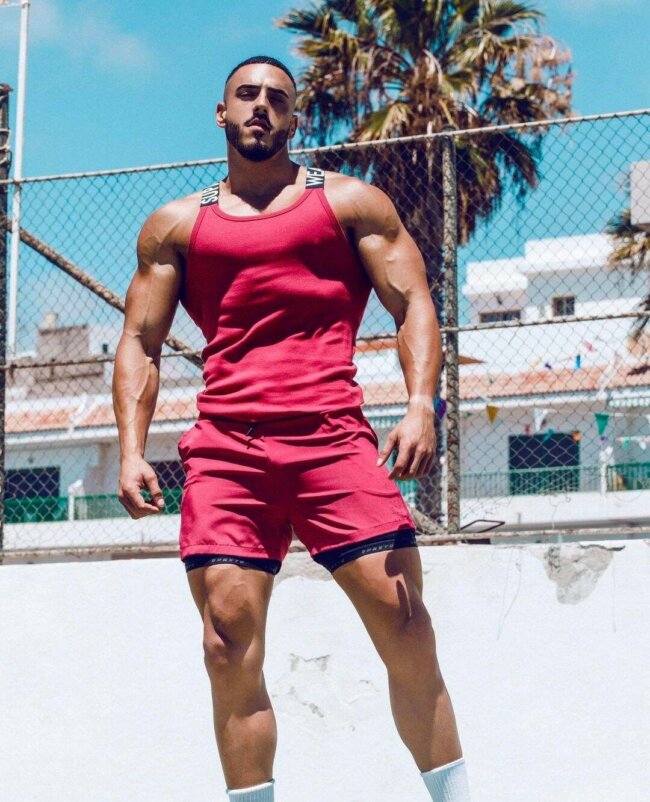 A bold look with bright trunks and a tank top. 