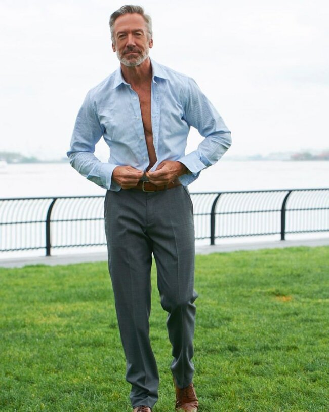 A contemporary look with a button-down shirt and dress pants. 