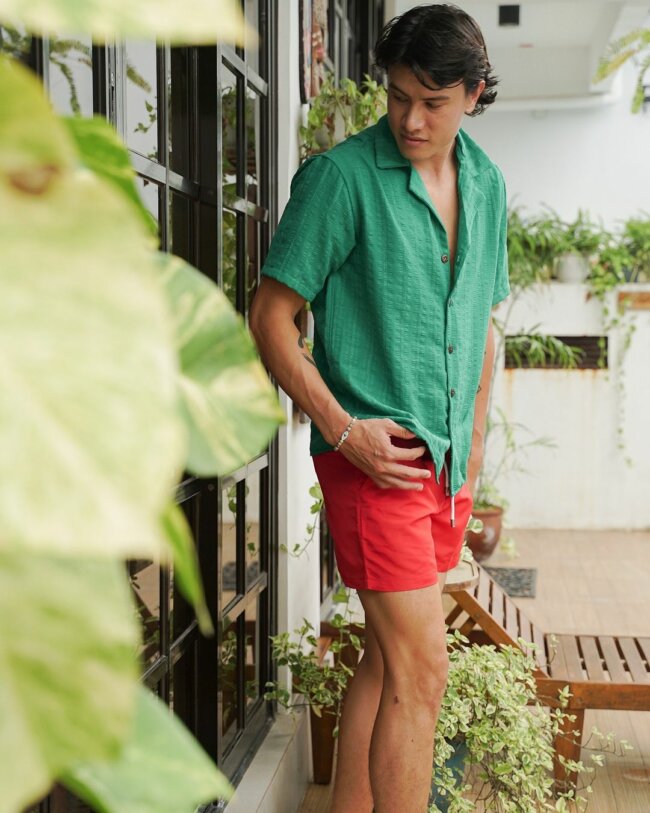A vibrant look with a contrasting trunks and shirt.