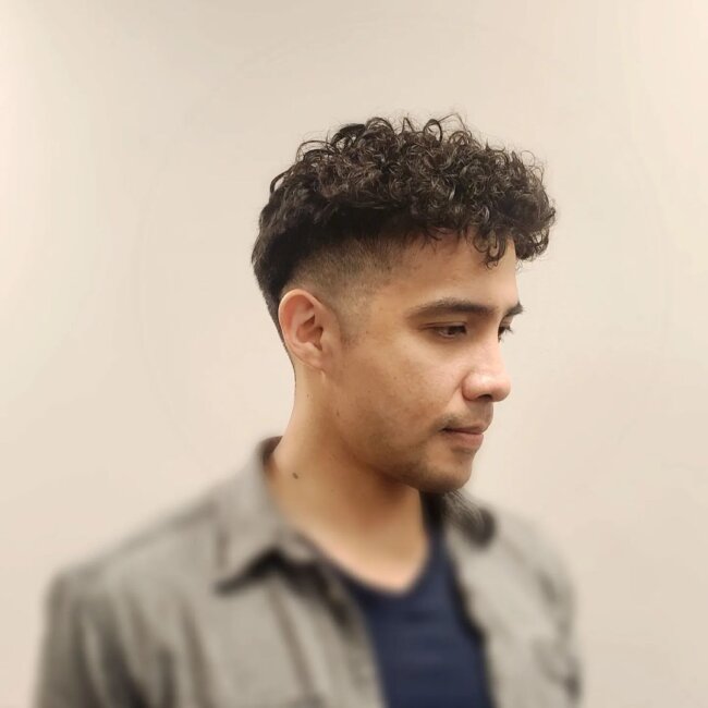 A sleek look with curly taper fade
