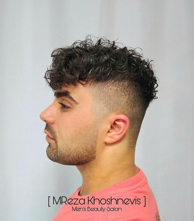 A classic hairstyle featuring a curly undercut with fringe. 