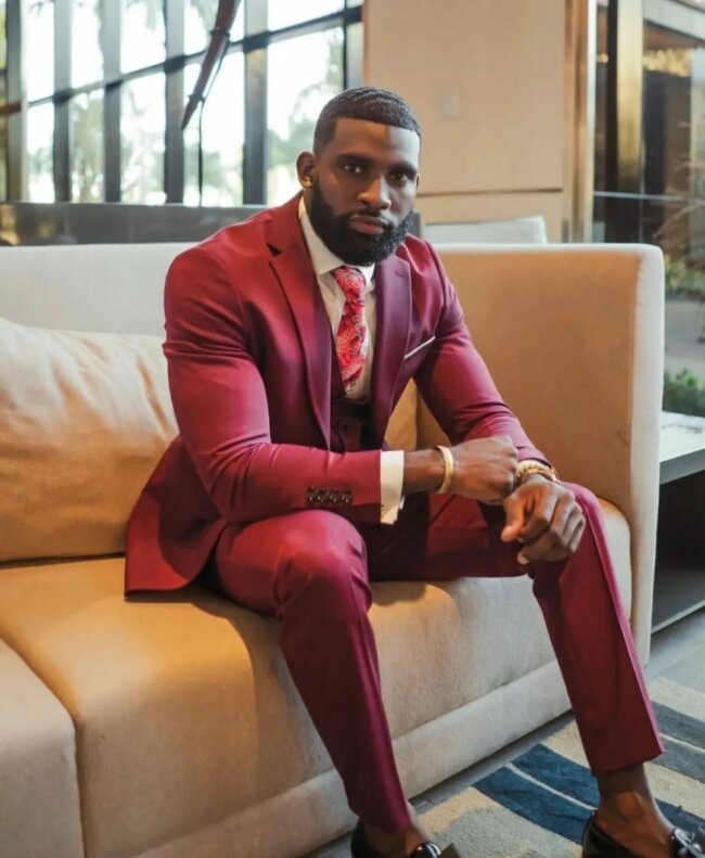 A bold appearance with a maroon suit. 