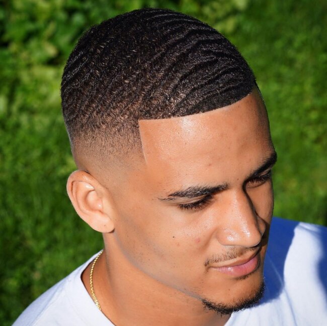 A visually appealing look with buzz cut and waves. 