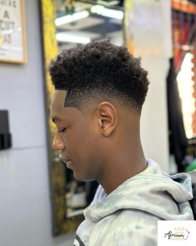A refined look with a curly high top fade. 