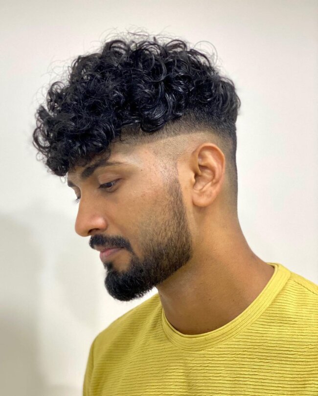 A smart look with curly low skin fade undercut. 