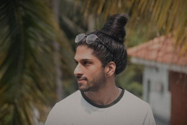 A bold look with heightened man bun.