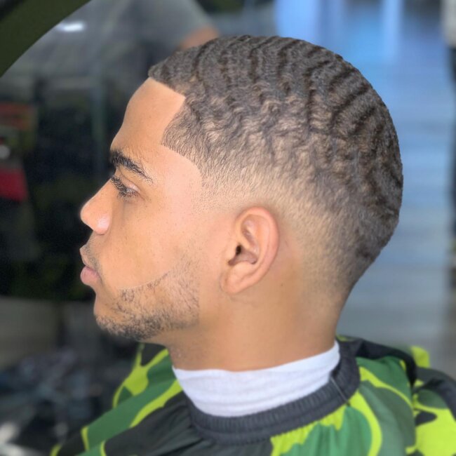A bold look with a low fade and waves.