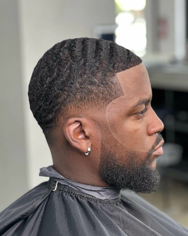 A polished look with low fade and waves. 
