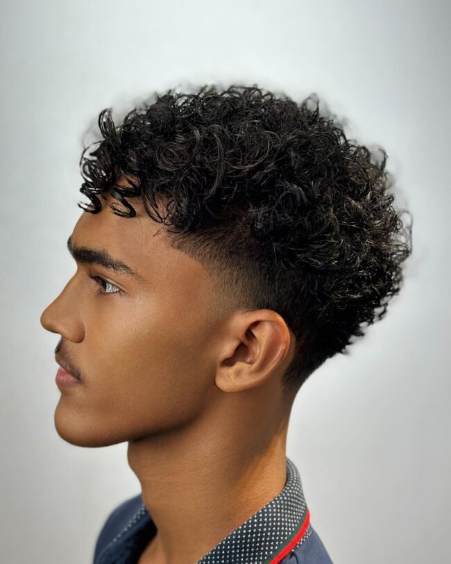 A bold look with short curly fade. 
