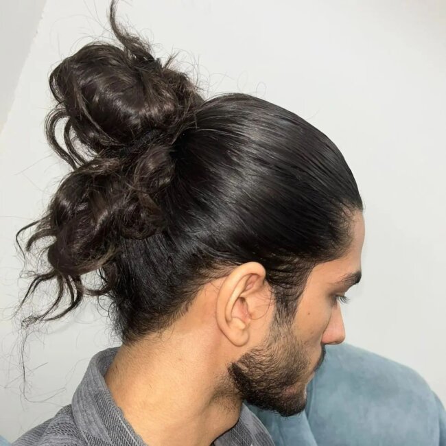 A bold look with slicked back man bun.